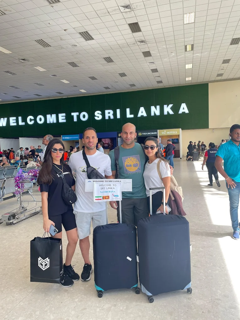 Mahesh greeting tourists at Colombo airport with SMA welcome sign